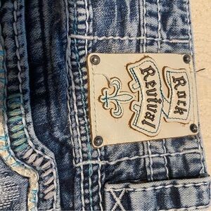Rock Revival Distressed Indigo Jeans with light blue stitching